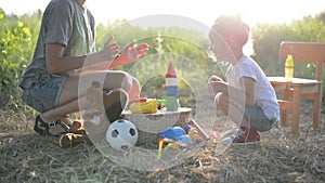 Toddler girl and mother playing with toys and clap on hands