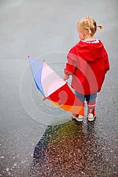 Toddler girl outdoors at rainy day