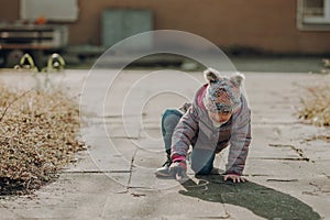 Toddler girl painted on the asphalt with a chalk, outdoor