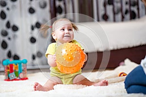 Toddler girl playing with ball indoor