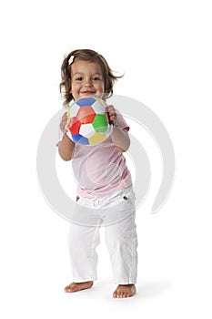 Toddler girl playing with a colored ball