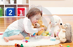 Toddler girl playing with her stuffed animals