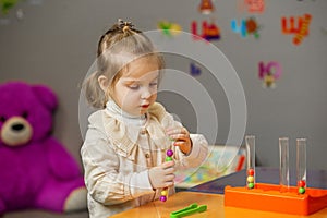 Toddler Girl Playing with Learning Bead Toy