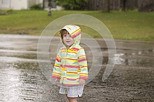 Toddler girl playing in the rain