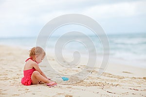 Toddler girl playing with sand