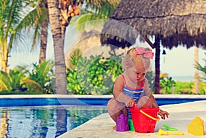 Toddler girl playing in swimming pool at beach
