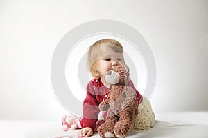 Toddler girl playing with teddy bear like animal