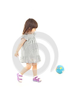 Toddler girl playing with world globe