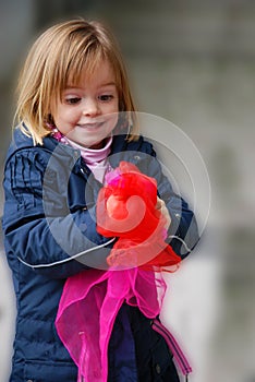 Toddler girl plays with silk scarfs