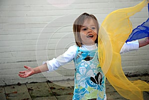 Toddler girl plays with silk scarfs photo
