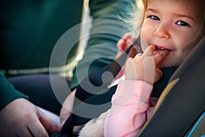 Toddler girl in safety car seat. Safety and security