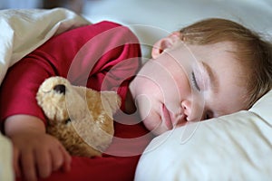 Toddler girl sleeping in bed