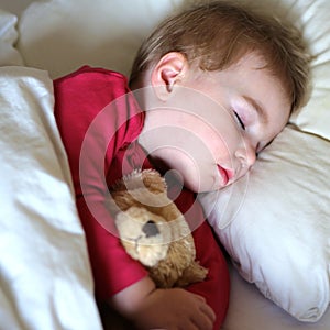 Toddler girl sleeping in bed