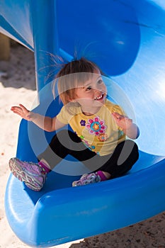 Toddler girl on slide with static electricity