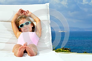 Toddler girl on sunbed