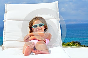 Toddler girl on sunbed