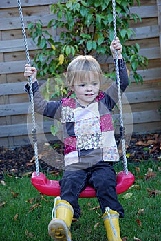 Toddler girl on a swing