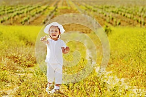 Toddler girl in   yellow  field