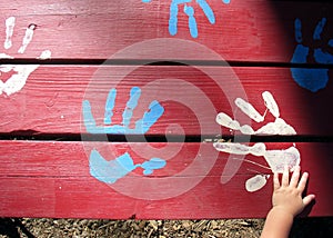 Toddler Hand on Paint Hands