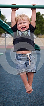 Toddler hanging from bars