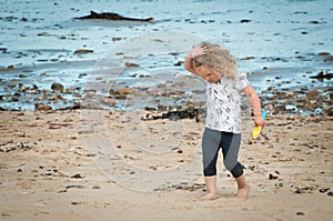 Toddler having fun exploring the beach