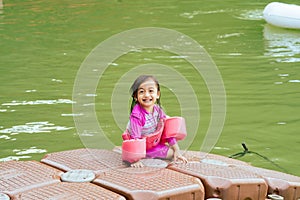 Toddler having fun in Lake Kenyir, Malaysia