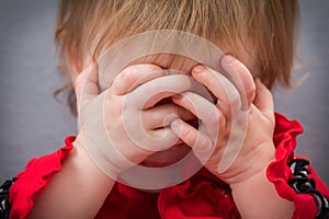 Toddler Hiding Behind Hands