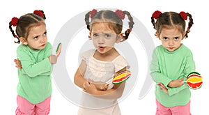 Toddler holding a lollipop wit