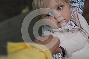 Toddler holds mom`s hand and looks at her, close-up. Little cute girl holds the hand of an adult on a walk. joint walks with the