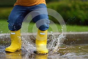 Toddler jumping in pool of water at the summer or autumn day