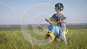 Toddler kid in funny glasses biking. Helping to ride a bike. Learning to ride a bike concept.