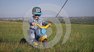 Toddler kid in funny glasses biking. Helping to ride a bike. Learning to ride a bike concept.