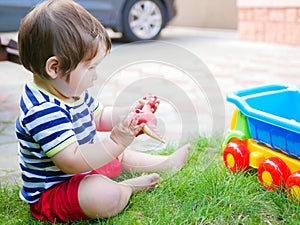 Toddler kid having fun playing with a toy dinosaur