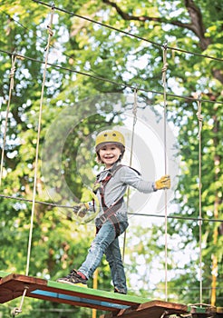 Toddler kindergarten. Active children. Balance beam and rope bridges. Toddler age. Cute child boy. Rope park - climbing