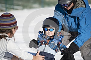 Toddler Learns to Ski with Dad While Mom Watches. Dressed Safely