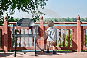 Toddler looking at river