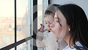 Toddler And Mother Looking In Window