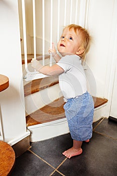 Toddler near stairs security safety guard gate