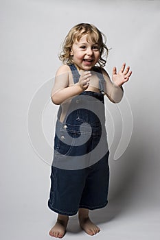 Toddler in overall clapping