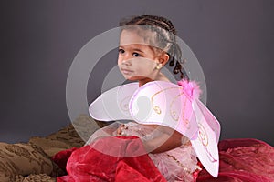 A toddler in Pink fairy wings