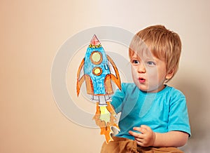 Toddler play astronaut and rocket liftoff photo