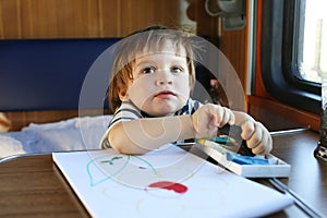 Toddler with playdough on train