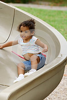 Toddler on playground slide