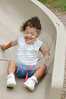 Toddler on playground slide