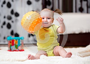 Toddler playing with ball indoor