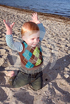 Toddler playing on beach