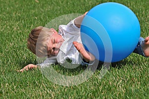 Toddler playing with blue ball