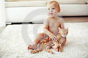 Toddler playing with cat