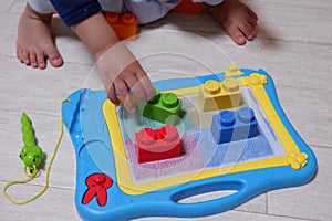 Toddler playing color match with blocks