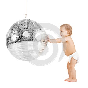 Toddler playing with disco ball
